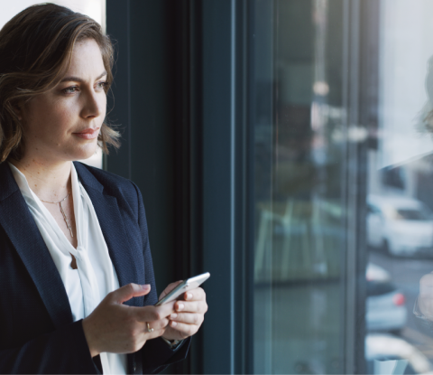 pension plan manager checking portfolio performance dashboard on her phone