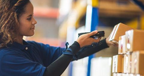 Woman in warehouse taking inventory