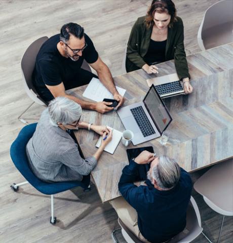 People seeted at a table attending a planning meeting