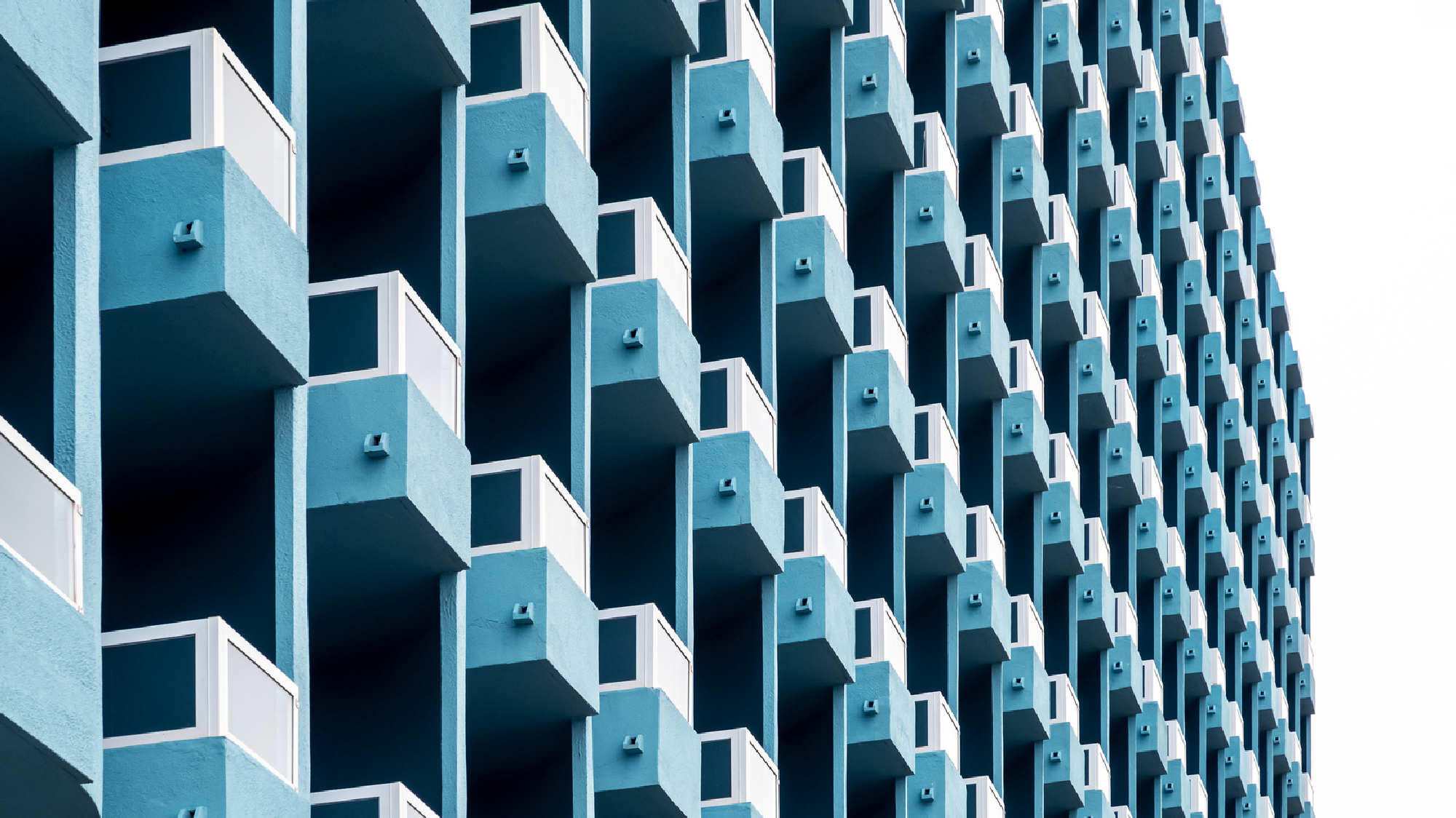 Blue facade adorned with balconies representing well-managed services.